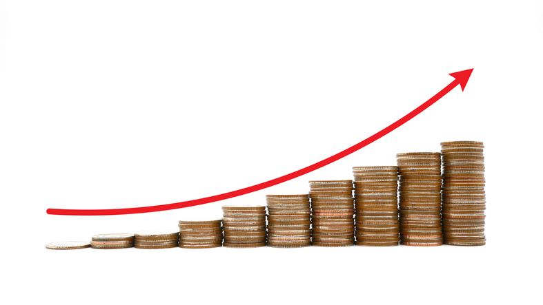 Growing stacks of coins on a white background